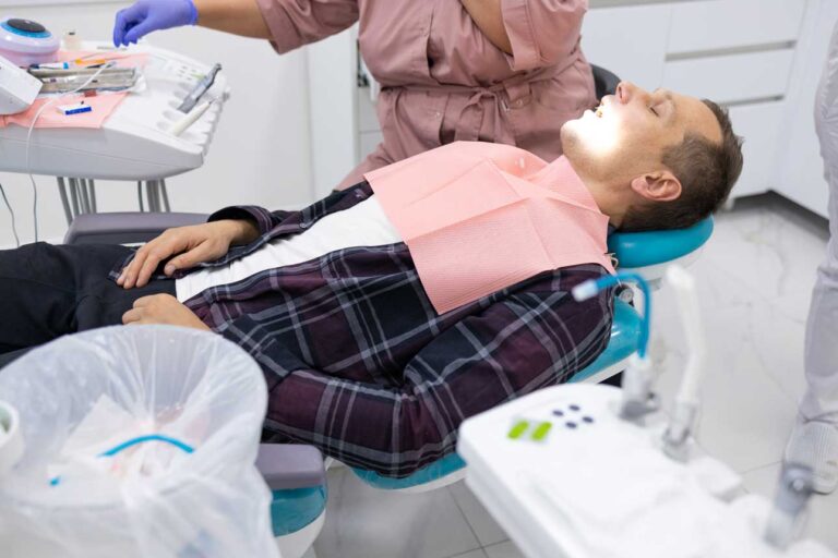 side-view-of-female-dentist-examining-male-patient-2023-11-27-05-02-00-utc